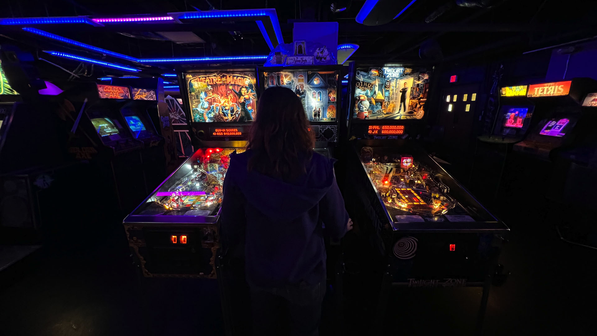 Woman playing games at Aftershock Classic Arcade